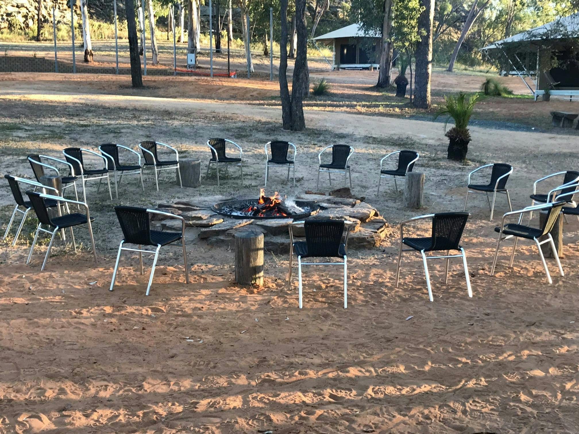 Chairs by the fireplace at our private glamping retreat