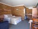 Queen bed, en-suite, kitchenette (couch, table/chairs, tv, wardrobe)
