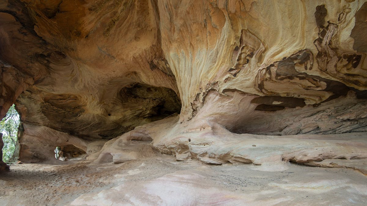 Image from inside sandstone caves with earthy, colourful tones