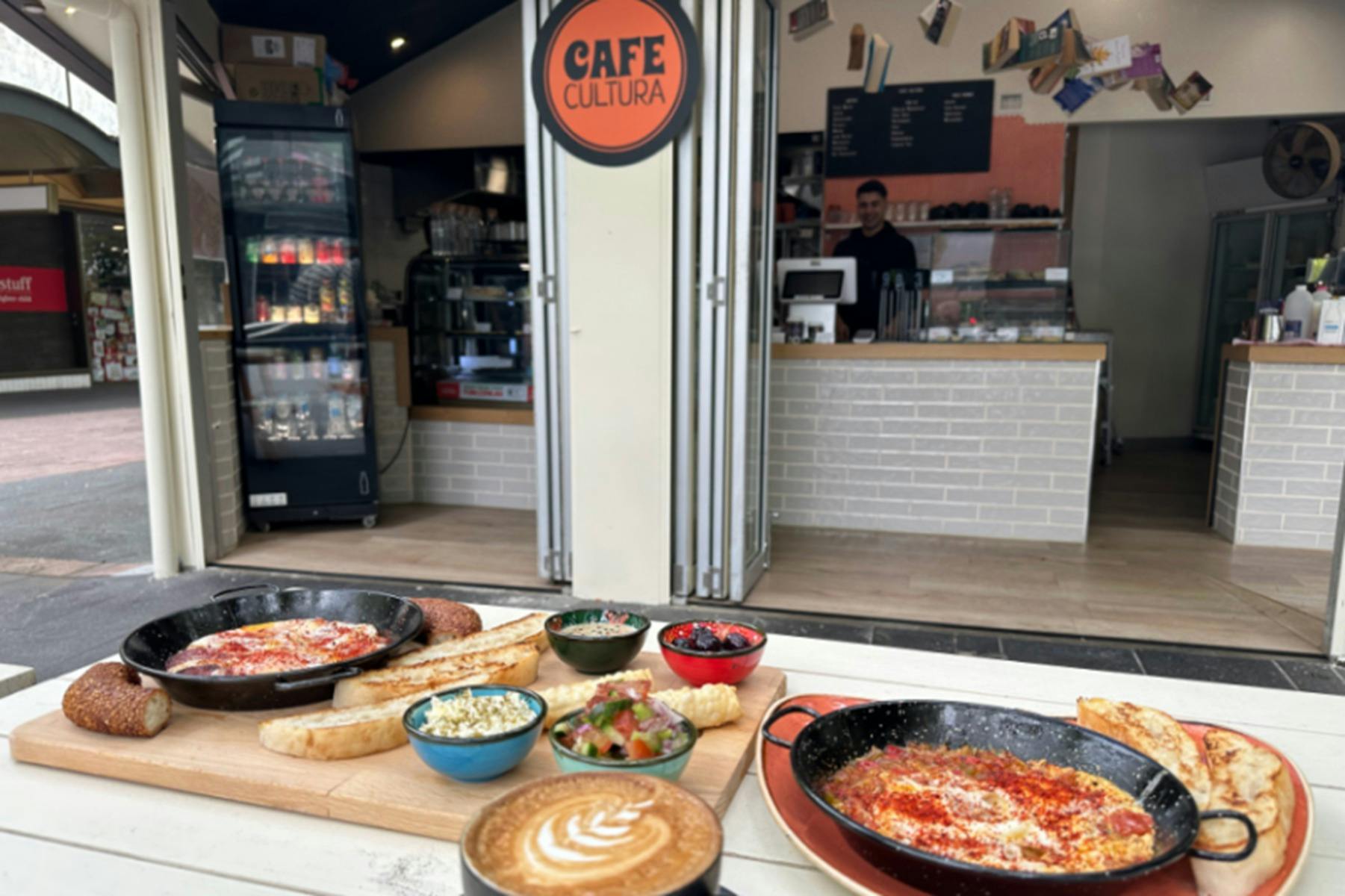 Various Cafe Cultura food offerings positioned on an outdoor table outside the cafe