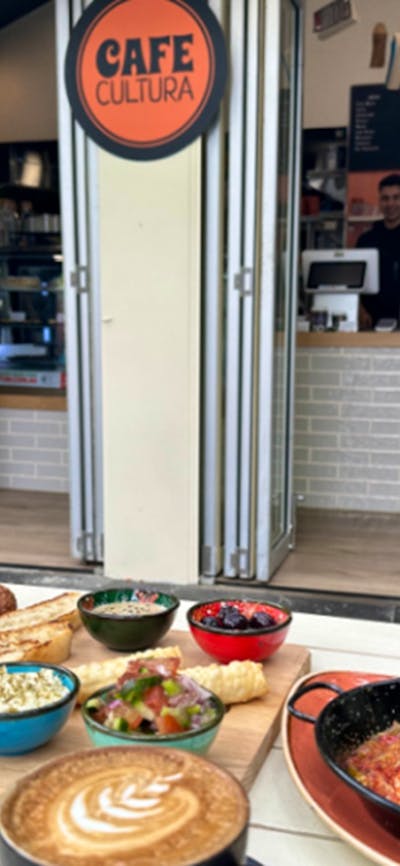 Various Cafe Cultura food offerings positioned on an outdoor table outside the cafe