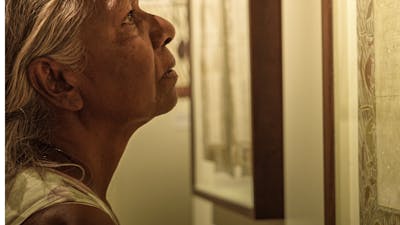 Close up of woman looking intently at an artwork