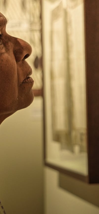 Close up of woman looking intently at an artwork