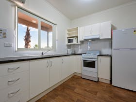 Looking at kitchen in 2-bedroom cabin