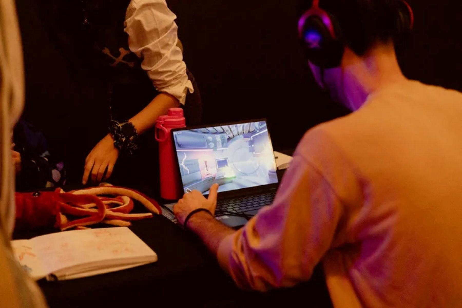 A man plays a game on a laptop computer