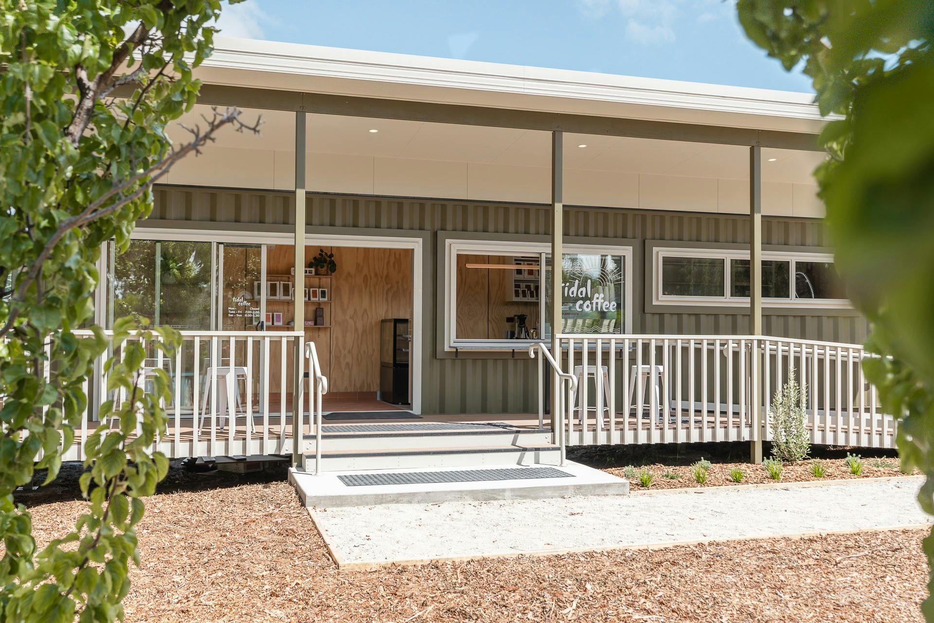 Photo of cafe entrance captured between trees