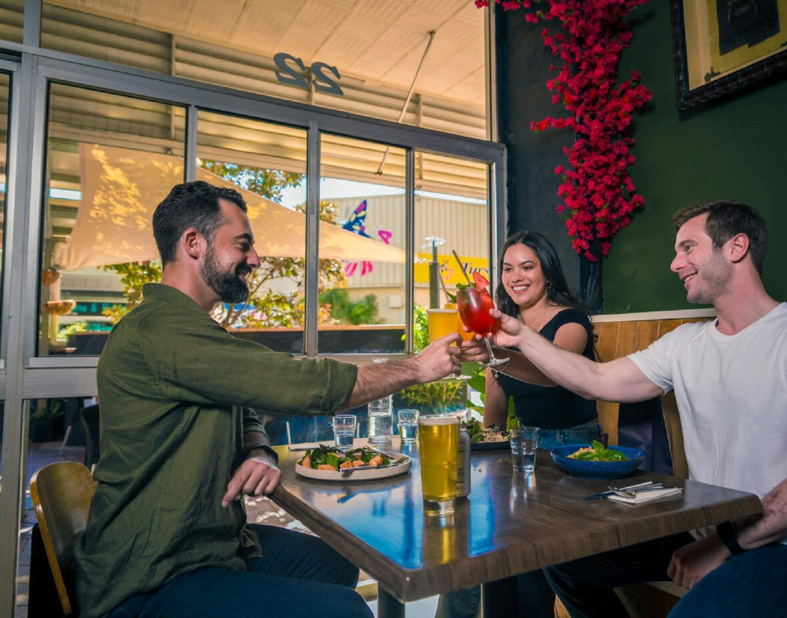 Group of friends having lunch and doing a cheers