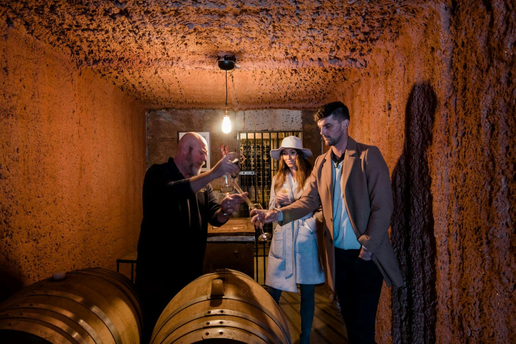 Vinny and some people barrel tasting the Shiraz, close-up