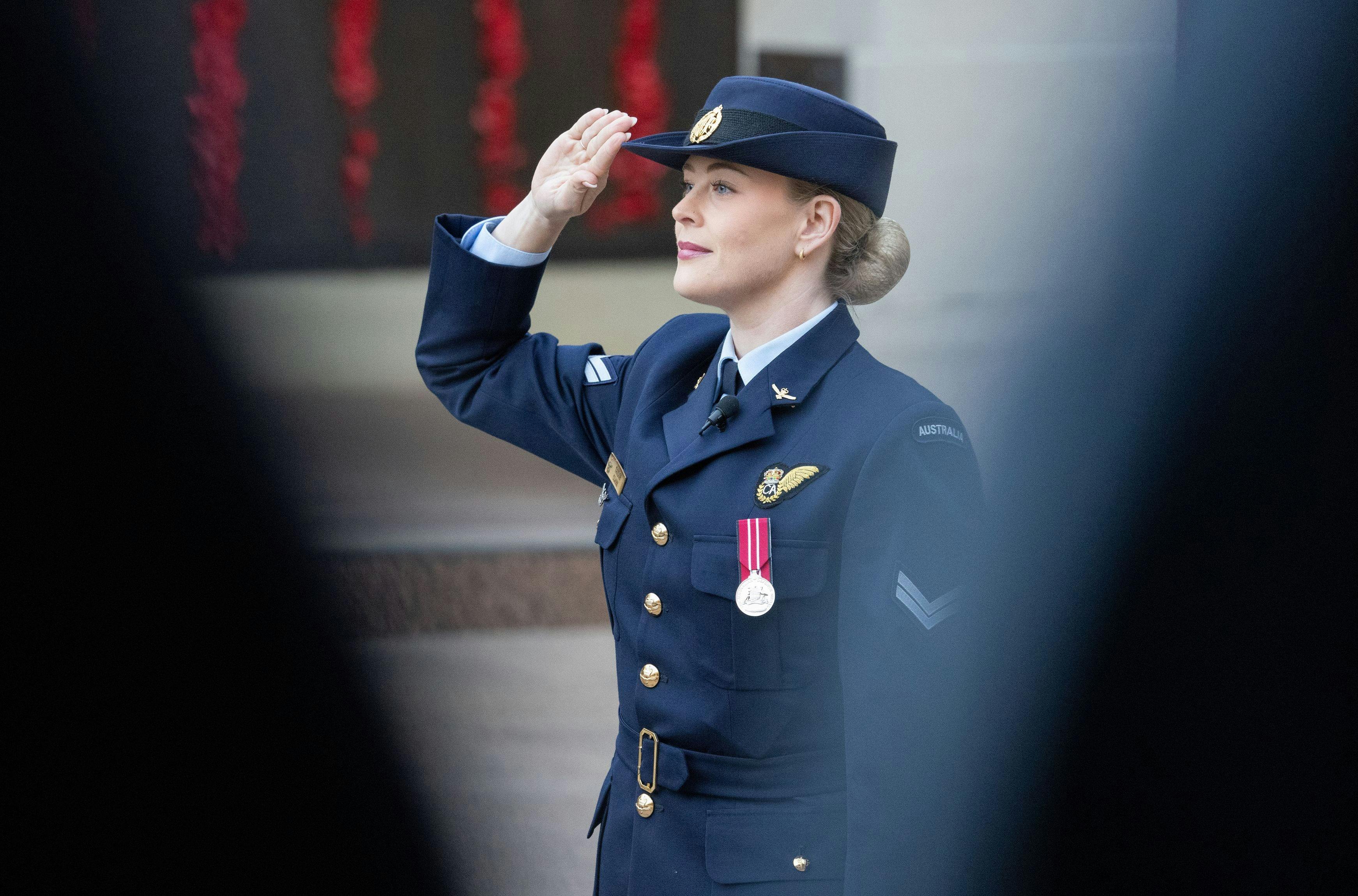 Royal Australian Air Force servicewoman saluting during ceremony