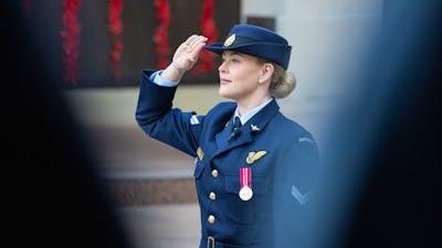 Royal Australian Air Force servicewoman saluting during ceremony