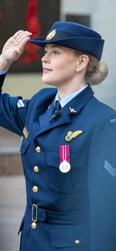 Royal Australian Air Force servicewoman saluting during ceremony