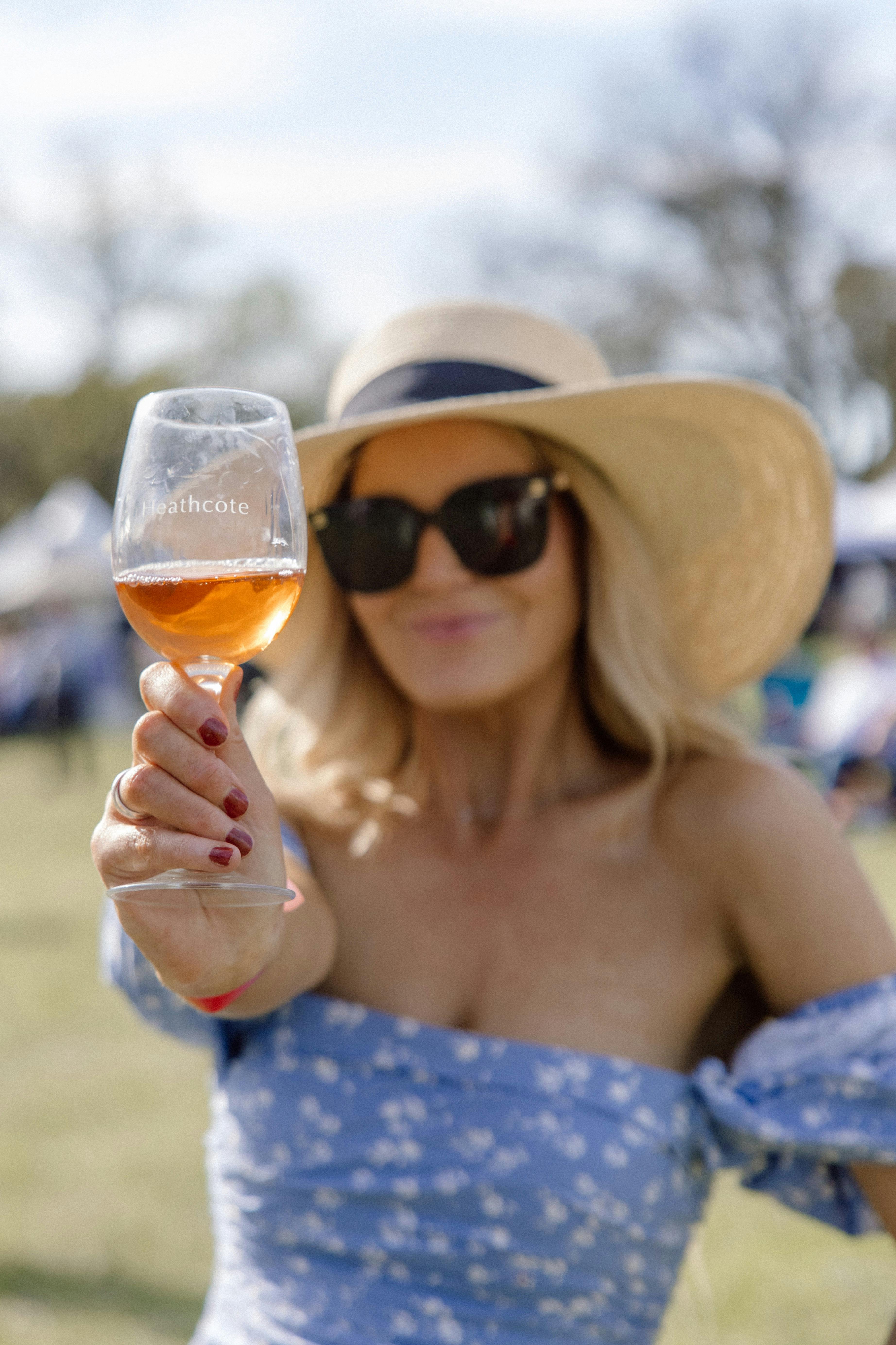 Woman holding glass of rose wine in a Heathcote glass