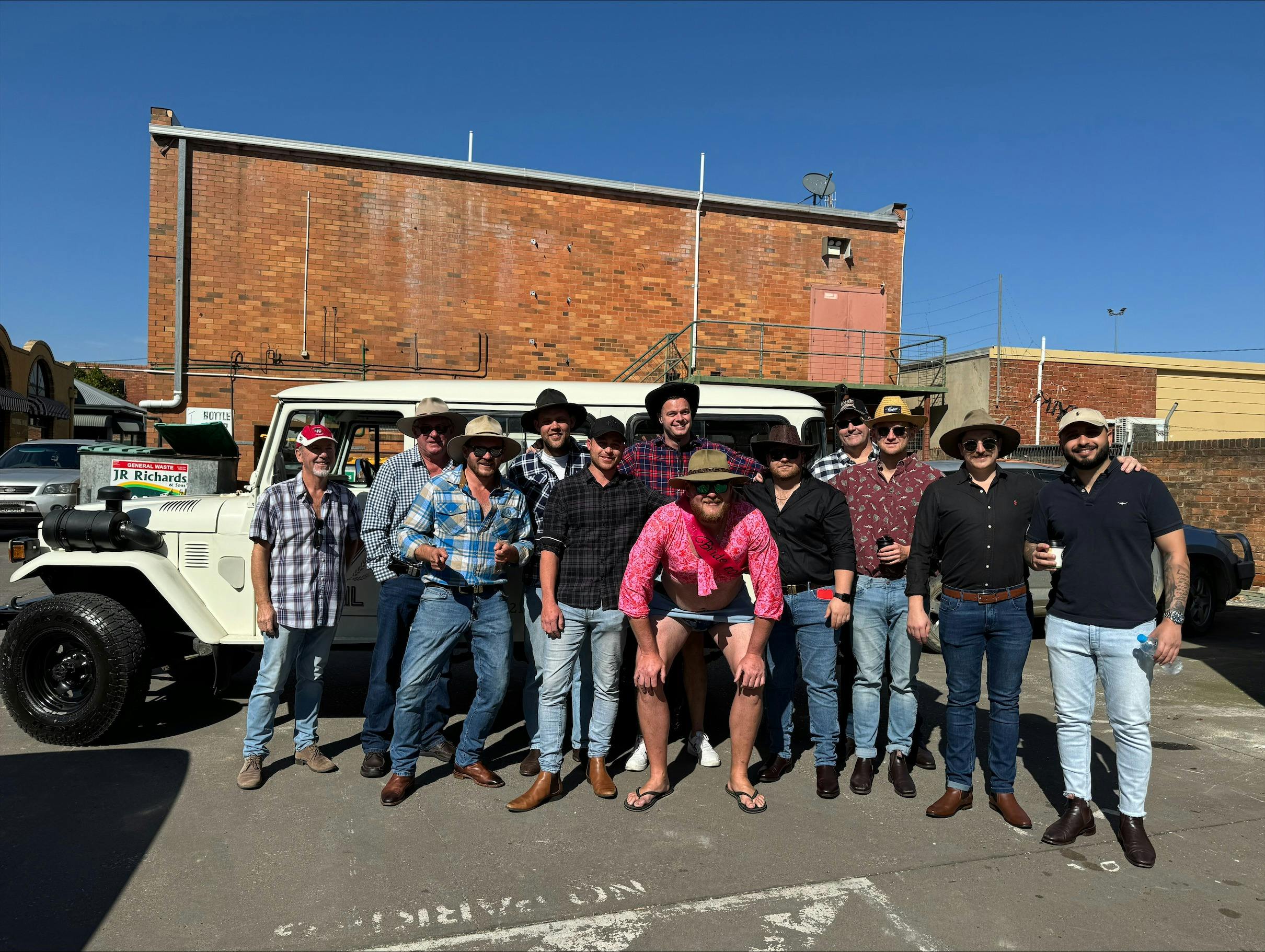 A group of 12 bucks in front of the Mudgee Ale Trail Troop carrier