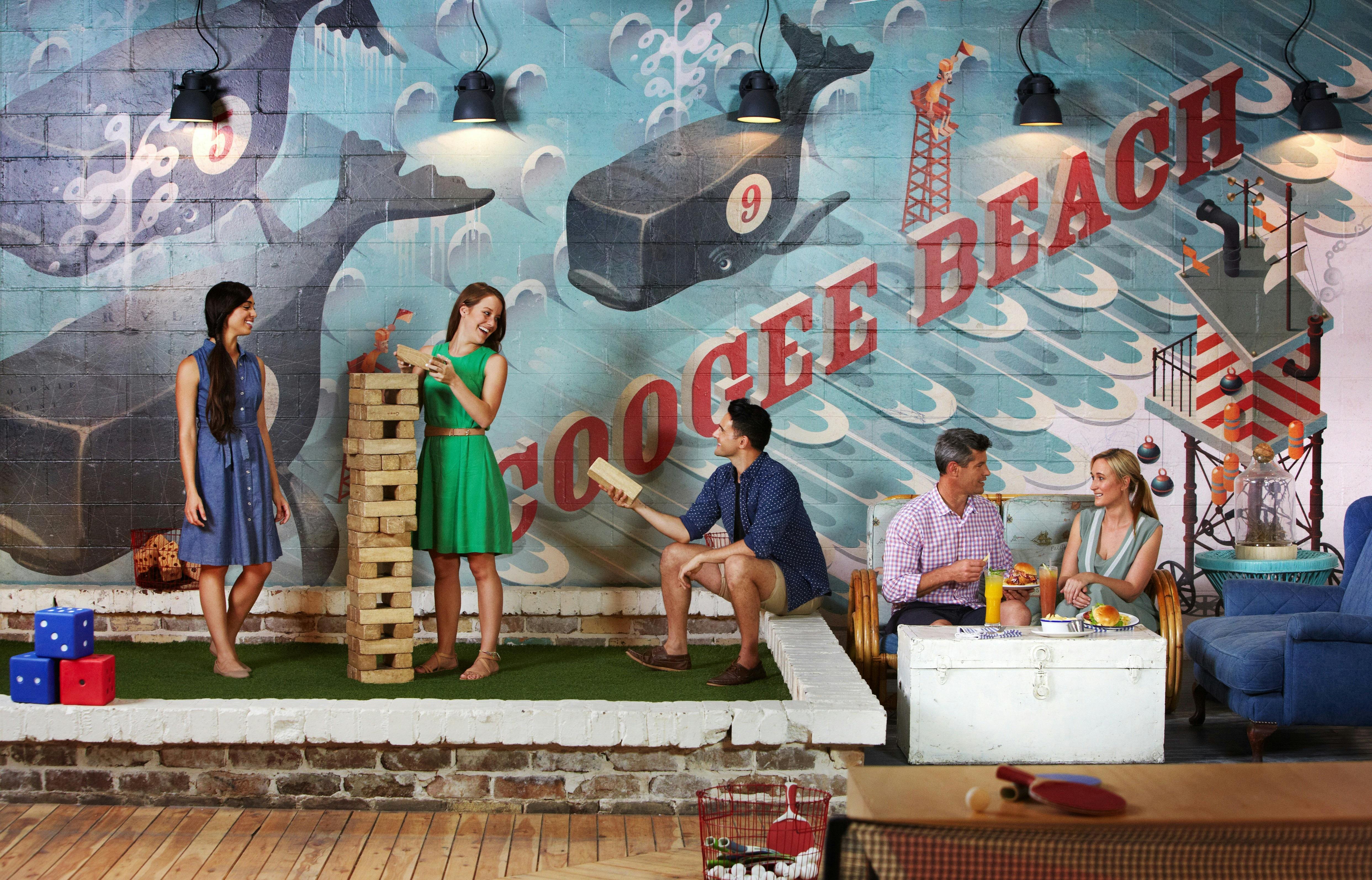 Friends dining and playing Jenga at Coogee Pavilion, Coogee