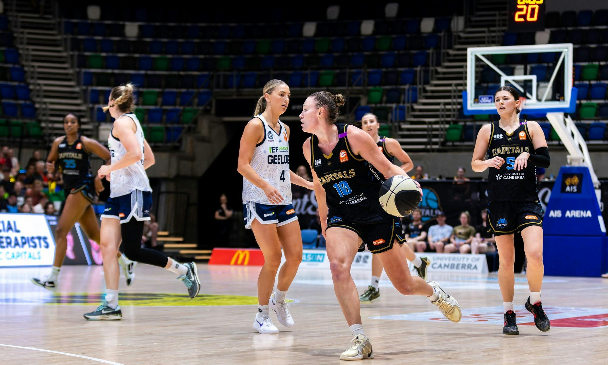 UC Capitals player driving to the basket for a layup during a WNBL game.