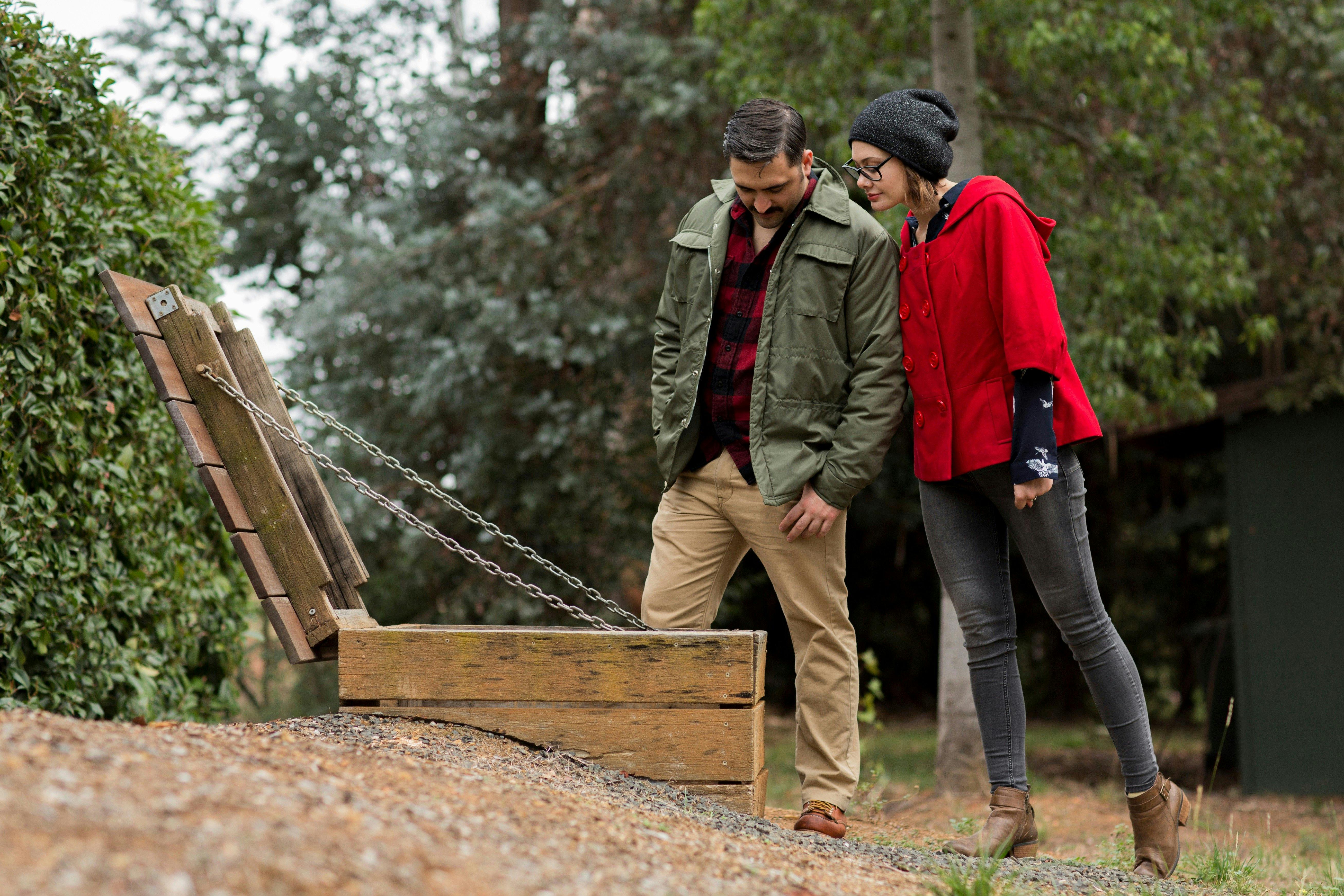 a couplelooking into the entry to an air raid shelter