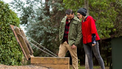 a couplelooking into the entry to an air raid shelter