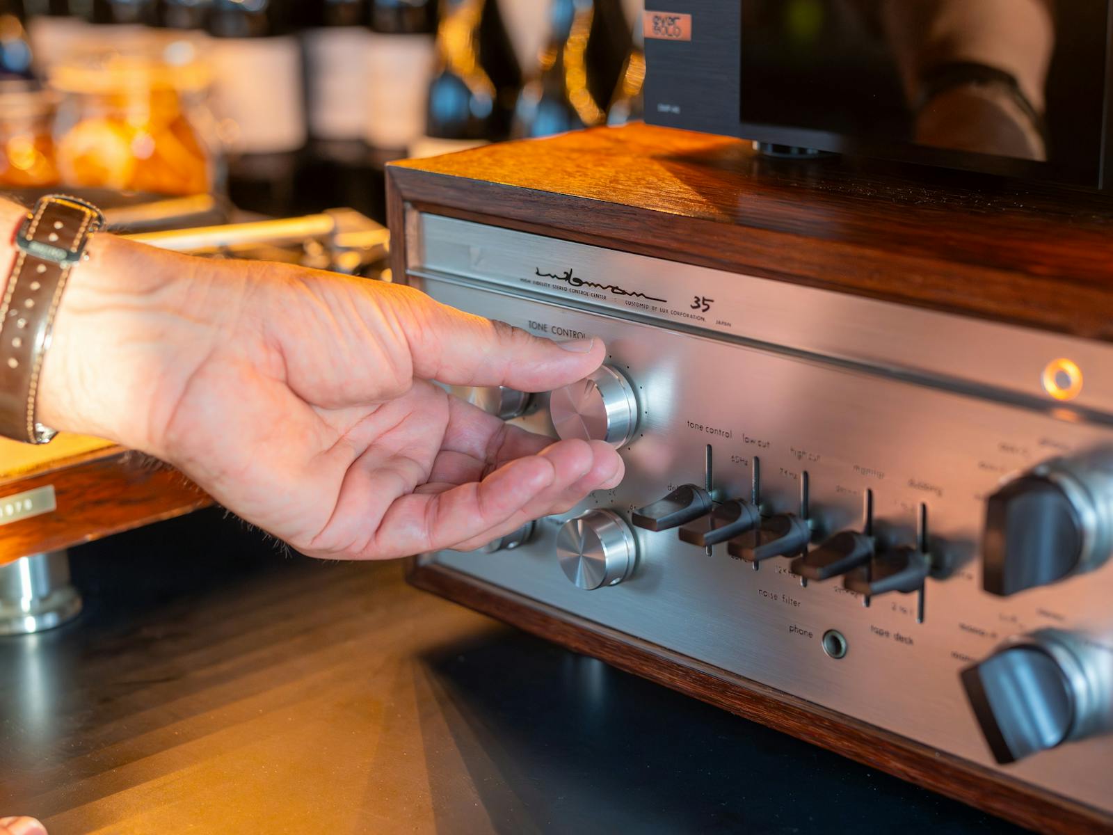 Dill Pickle Club bartender adjusting a Luxman amp