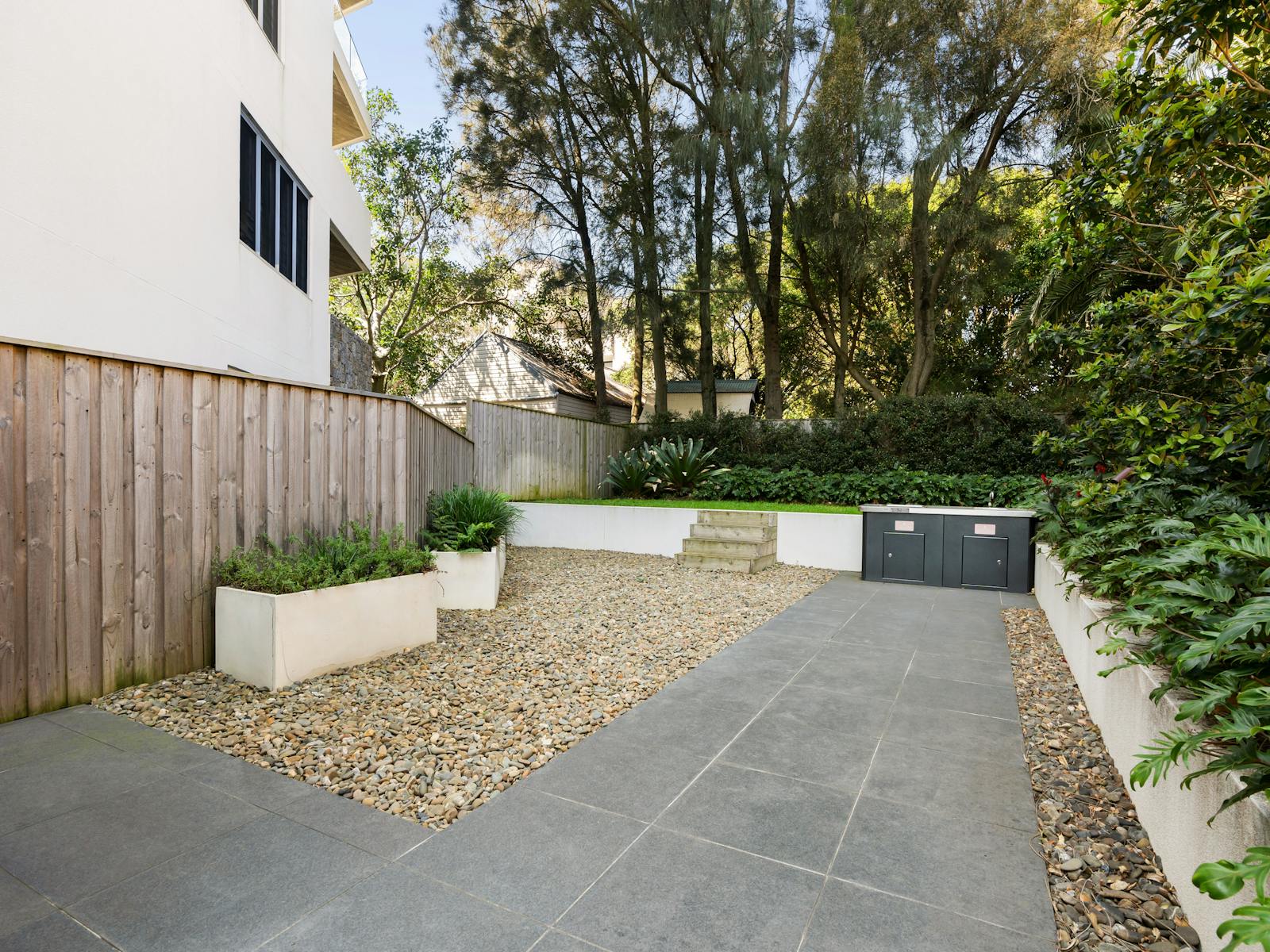 Neatly landscaped outdoor area with gravel paths and greenery.