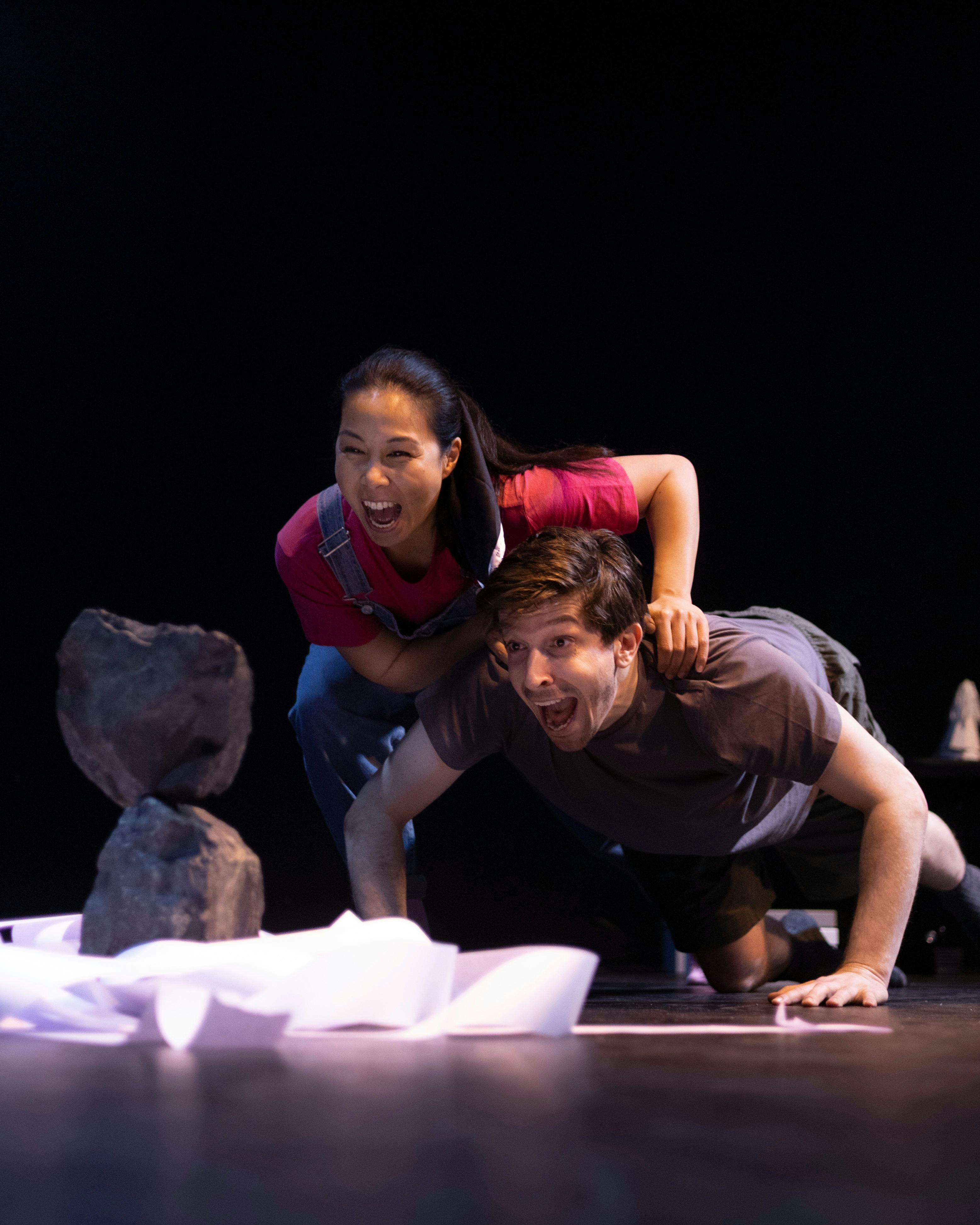 Man and woman yelling at a rock