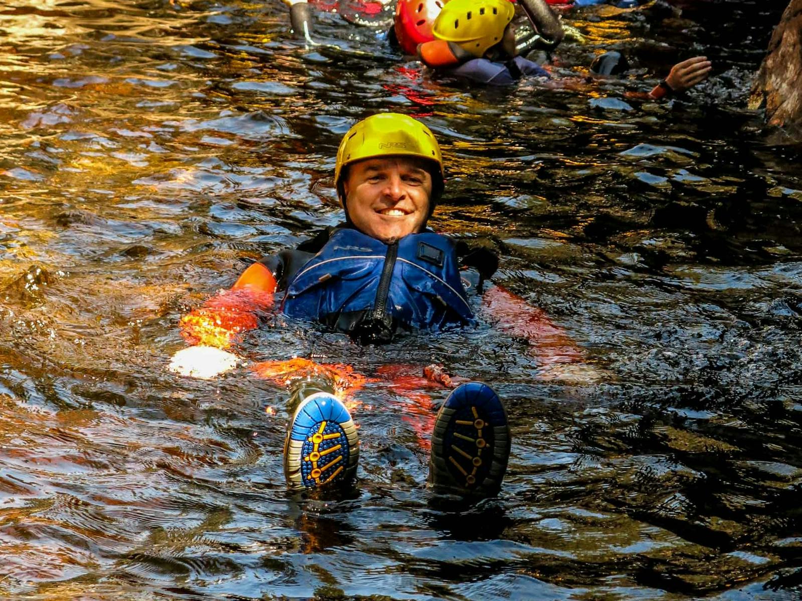 A canyoner floating down at river at Cradle Mountain