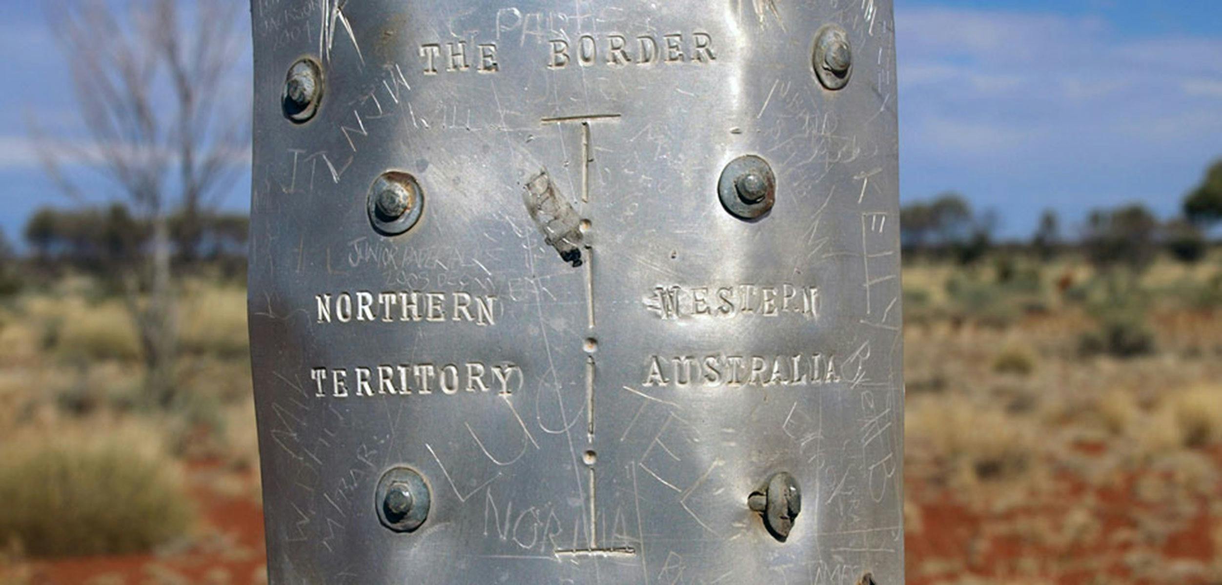 Remote border sign between Northern Territory and Western Australia.