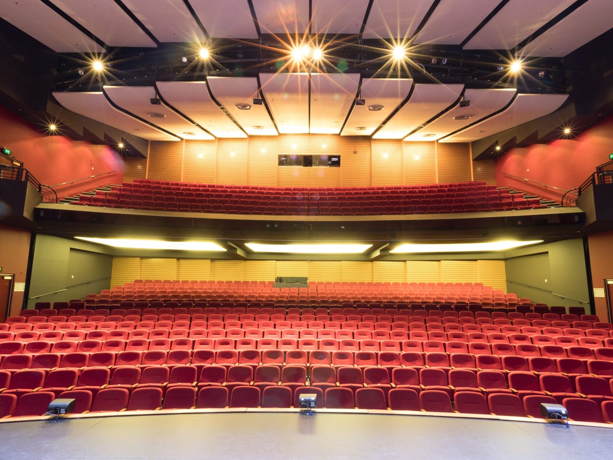 An 800 seat auditorium photo taken from stage looking into stalls and dress circle seating.