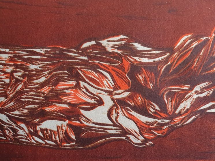 Section of a brown and orange woodcut print by artist Elaine Camlin