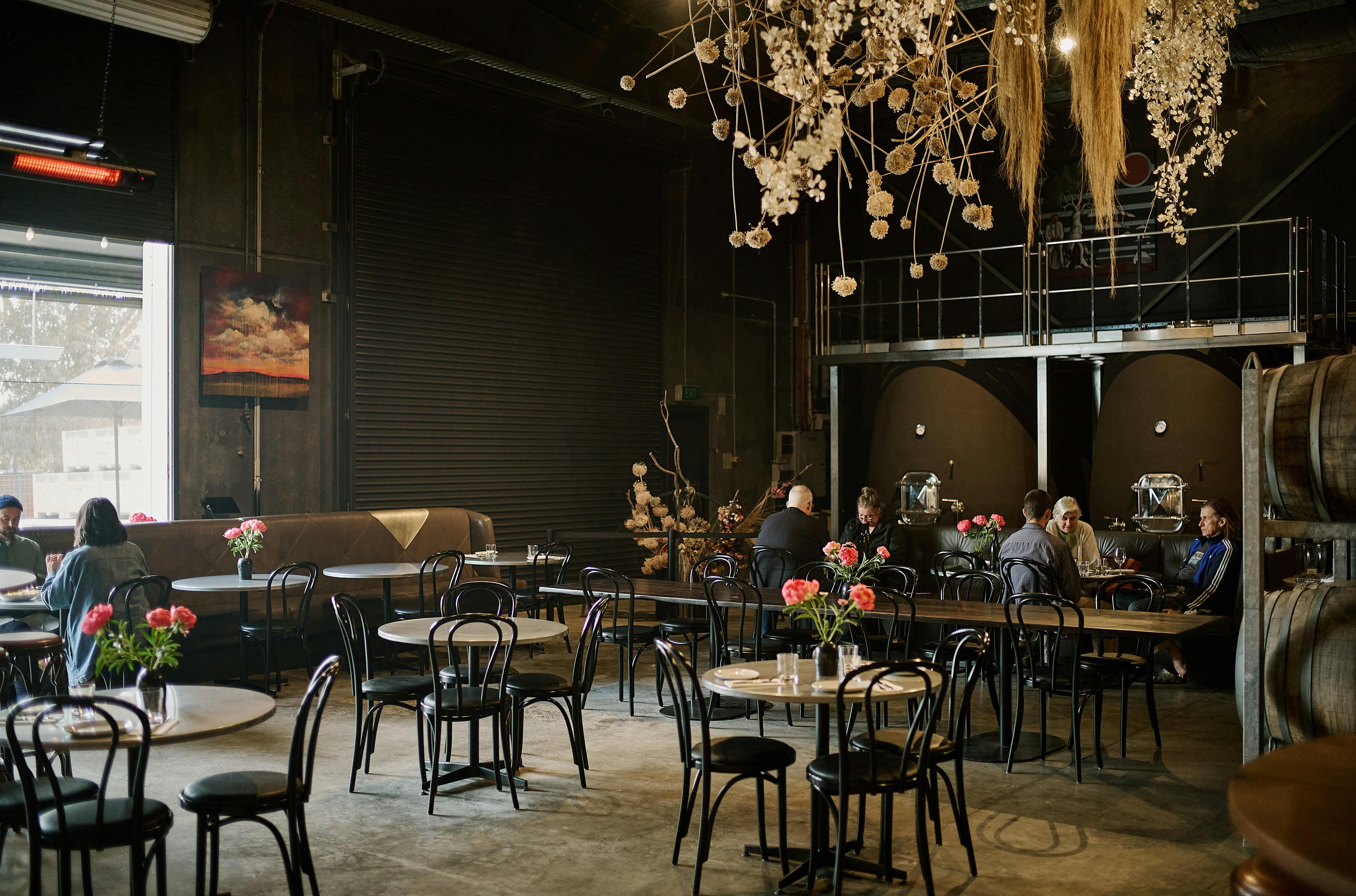 The dining room with hanging floral installation