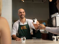 Barista serving coffee