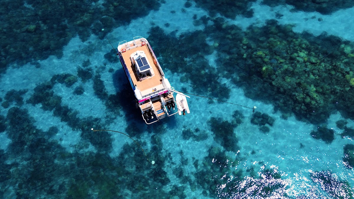 Drone footage of pure snorkelling top deck for lounging the vessels solar panels can be seen as well