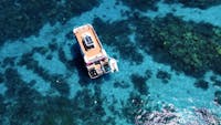 Drone footage of pure snorkelling top deck for lounging the vessels solar panels can be seen as well