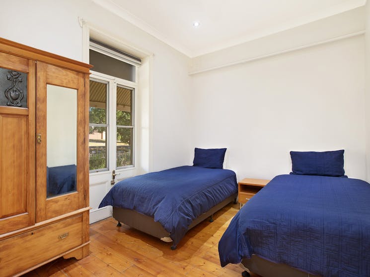 This bedroom offers two king single beds on the raised ground floor.