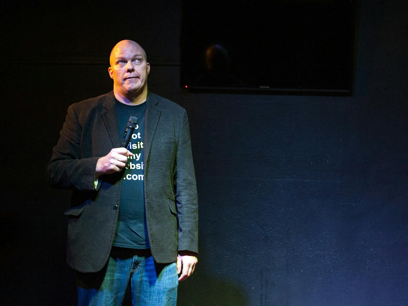Comedian Sean Morahan stares comically into space while perfroming