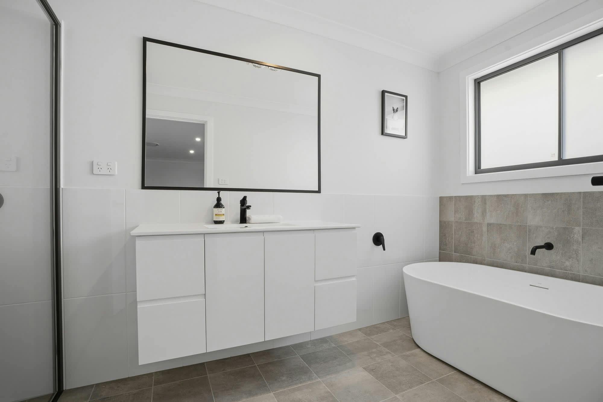 Bathroom with vanity, shower, and bath