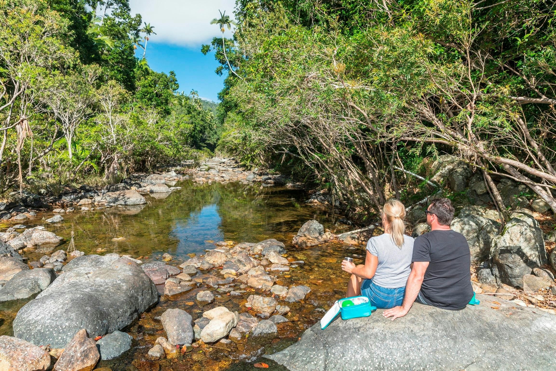 Couple relaxing at Impulse Creek, Conway National Park, Airlie Beach, Whitsunday Segway Tours