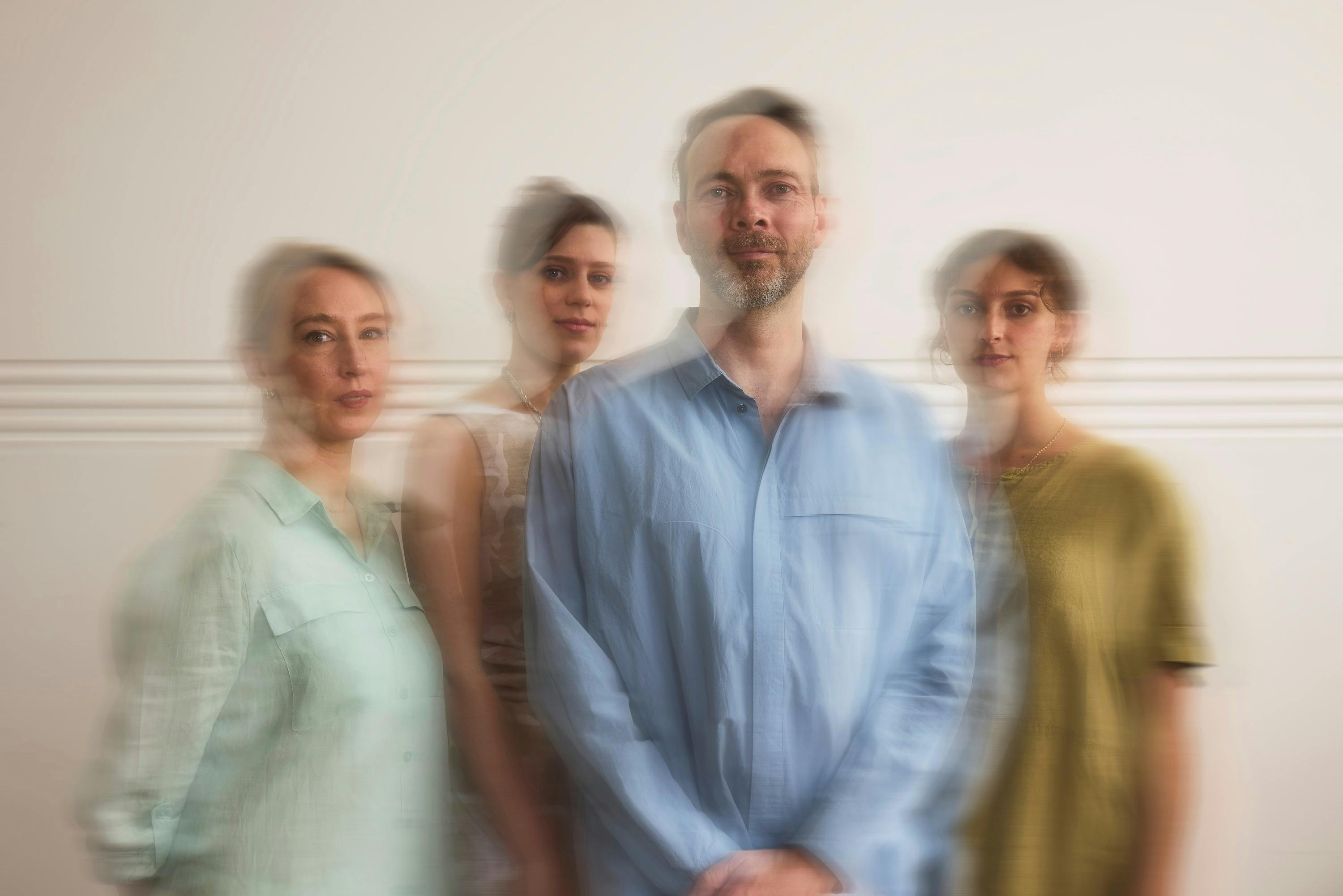 Artistic photo of four people with colourful clothes.