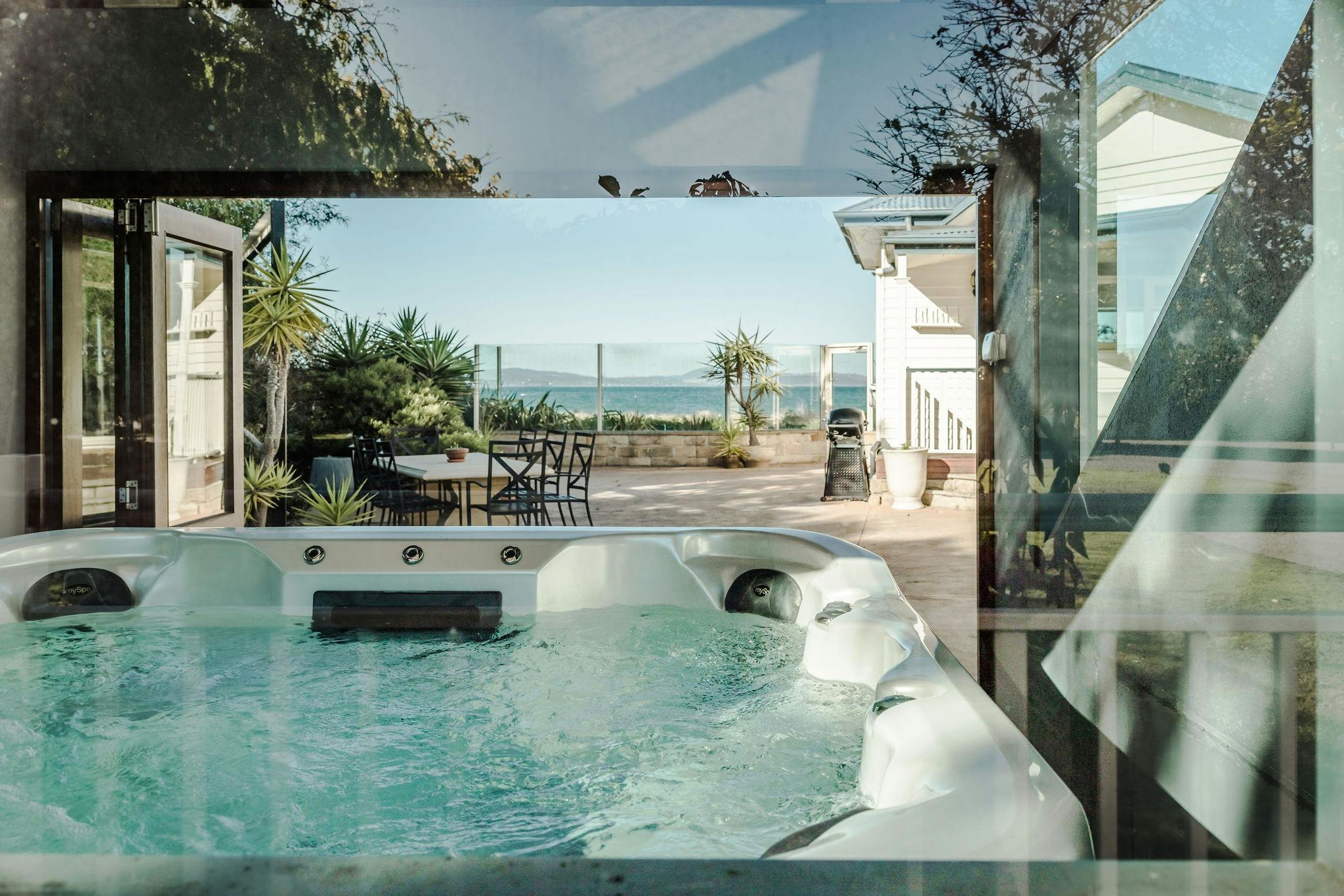 A shot of the hot tub throught the back window showing the ocean view viable from the hot tub