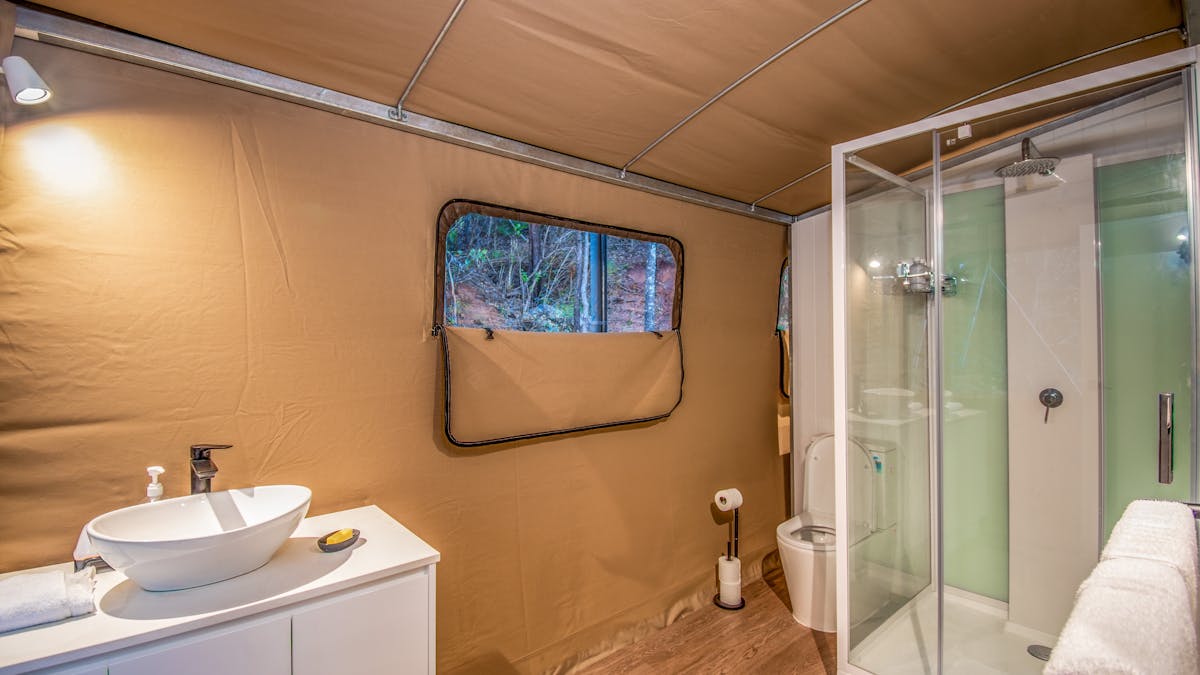 Enclosed glass shower toilet basin vanity