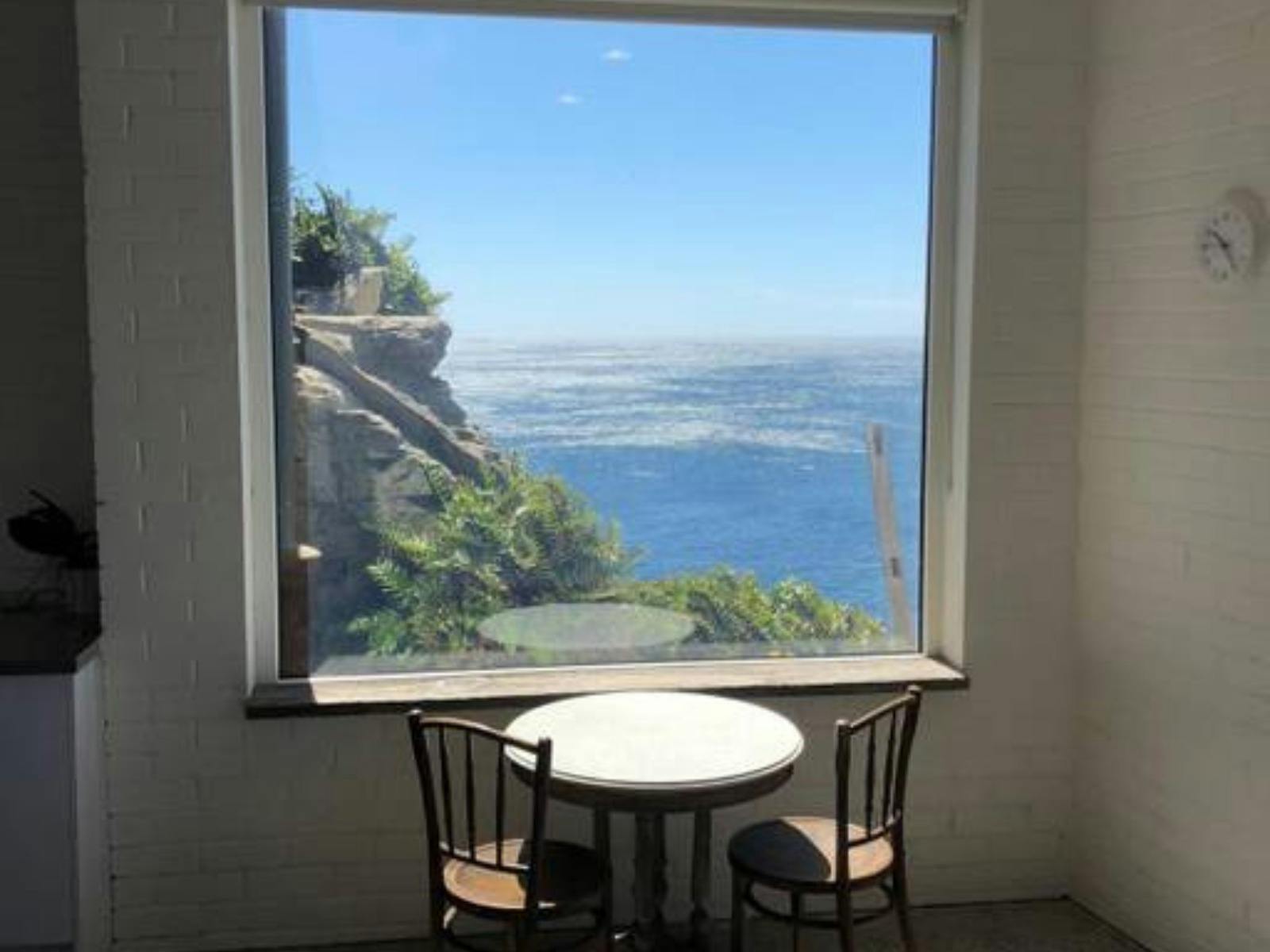 Cliffside apartment with breathtaking views of the ocean and rocky coastline.