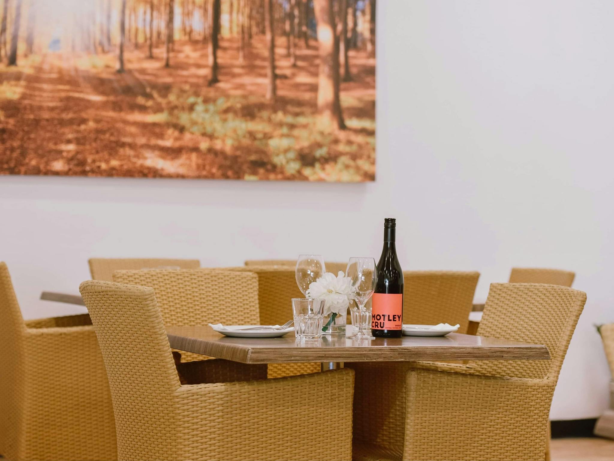 Inside seating with bottle of wine and glasses on timber table