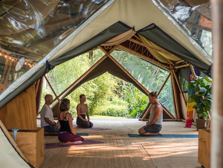 Students practicing yoga at Bamboo Yoga School, Byron Bay