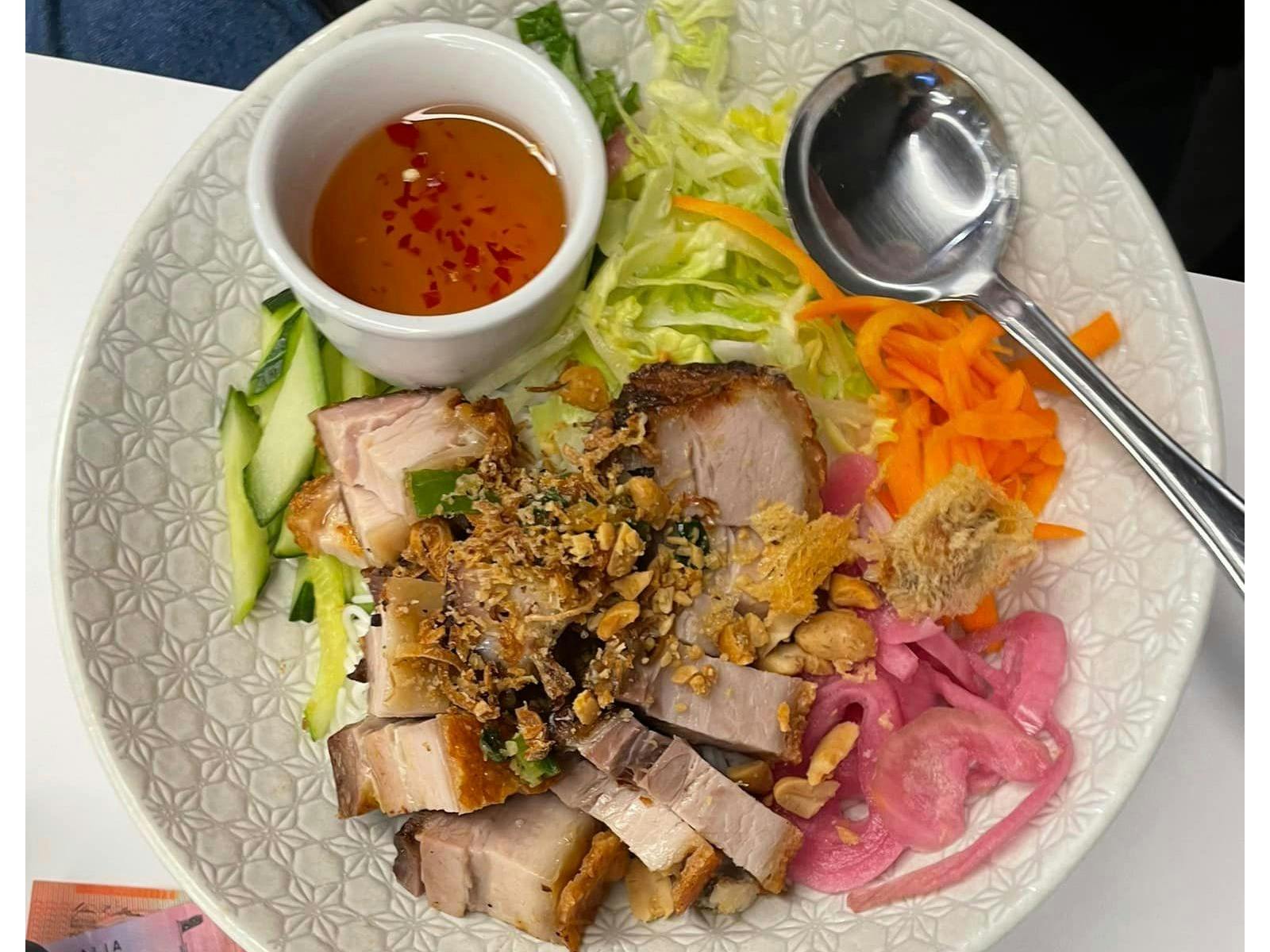 a bowl of vermicelli noodles salad with crackling pork