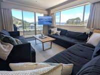 Lounge area with couches, television and a view overlooking Spion Kopje Mountain Range