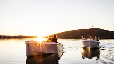 Two boats on the water at sunset