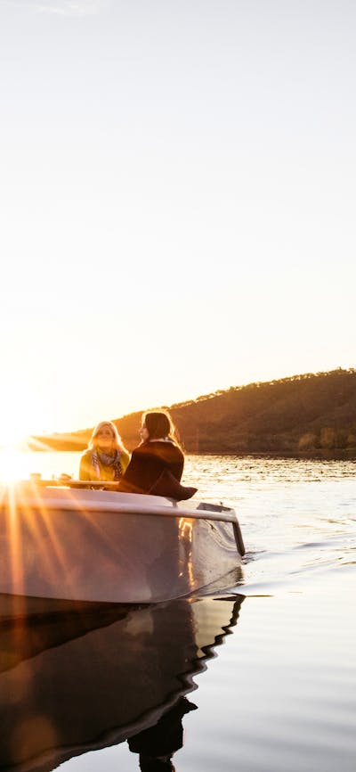 Two boats on the water at sunset