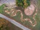 Aerial View of art project depicting a snake looping around Marmungan Rock