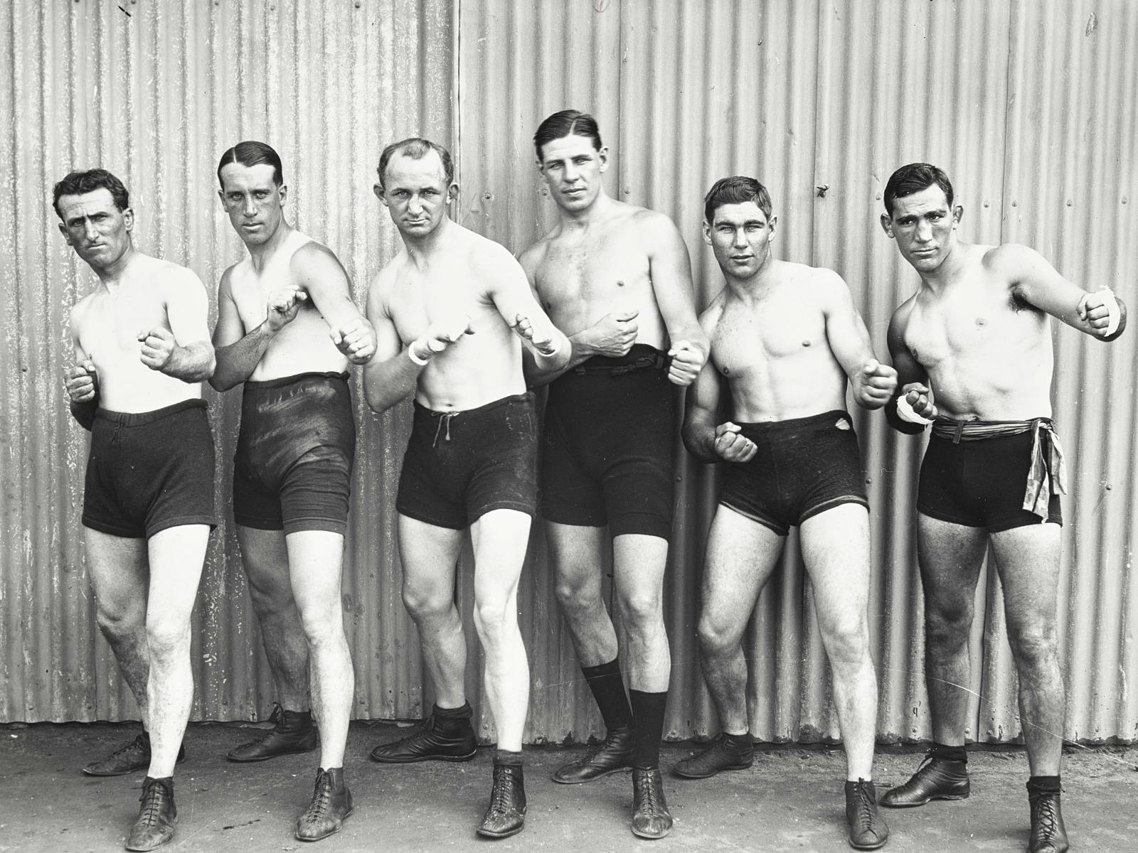 6 boxers lined up, black and white photograph