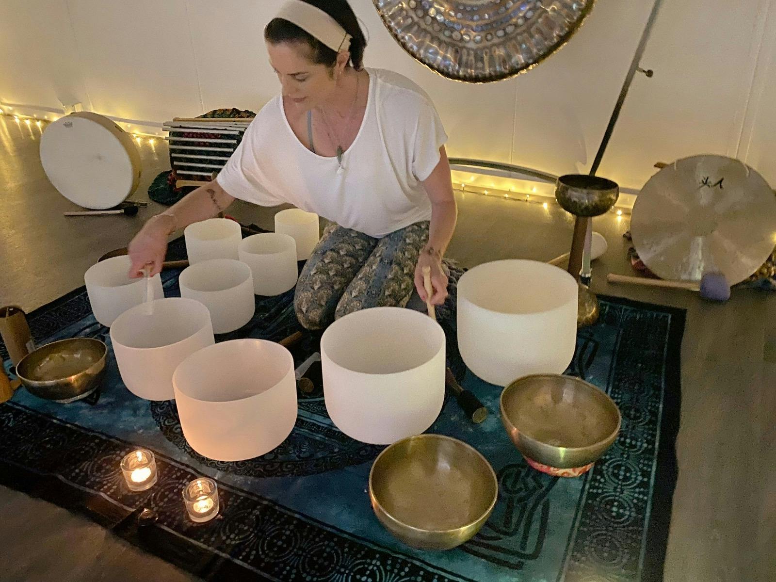 Photo of Natalie Grace playing crystal singing bowls - from above.
