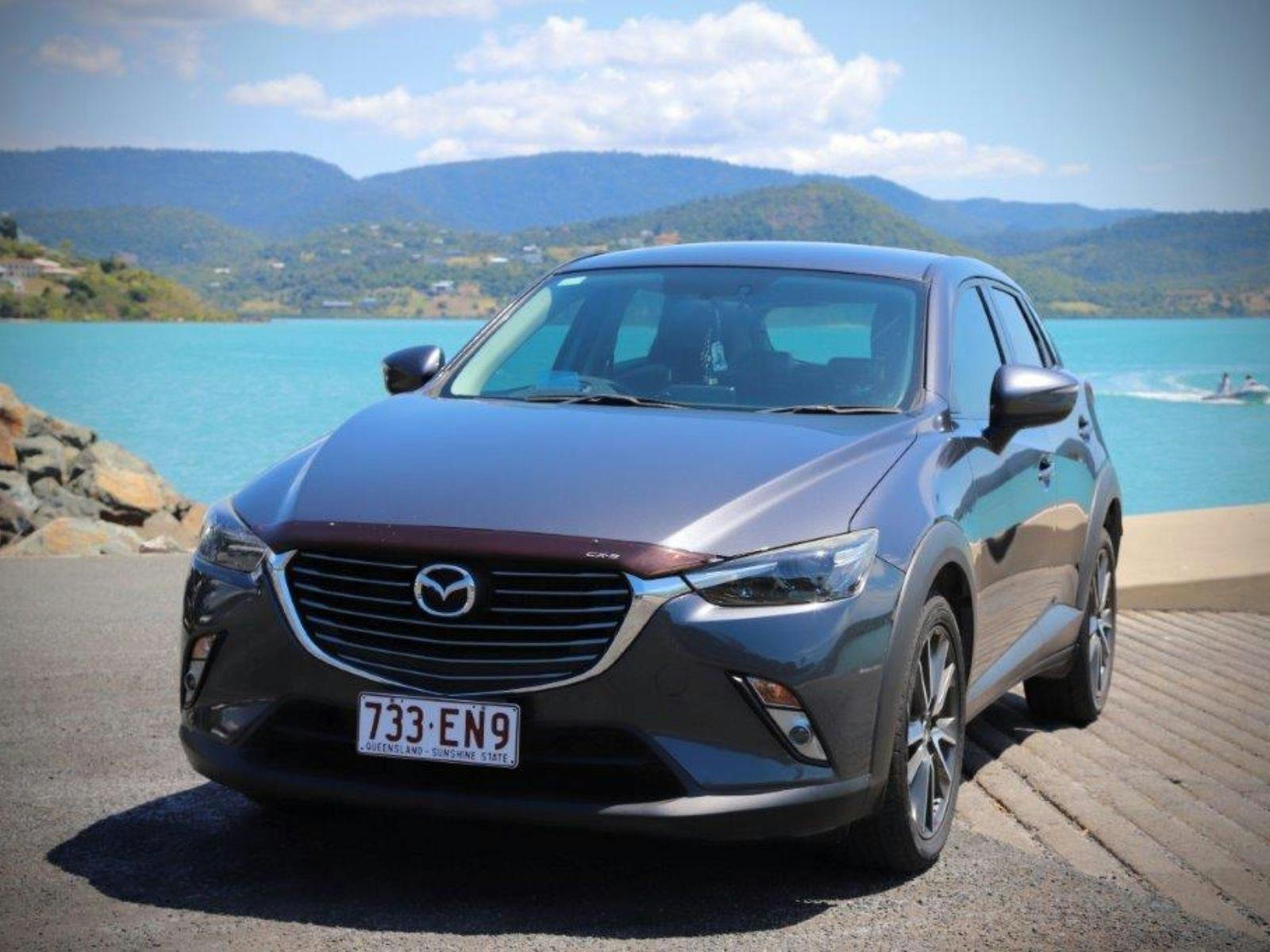 Heart of Reef Car for rent in front of Airlie Beach Background